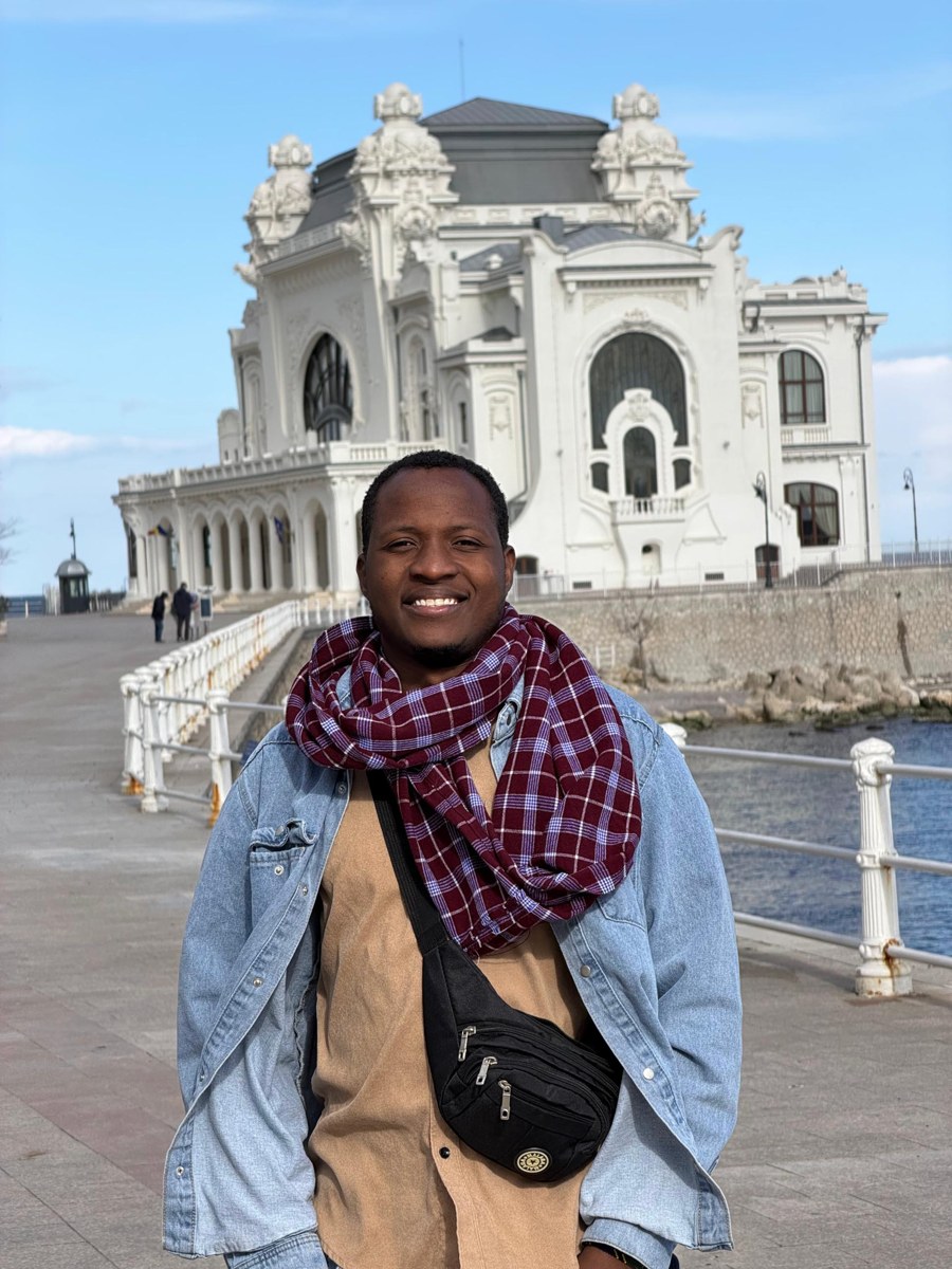 Anthony Maduhu smiling outdoors during his travels